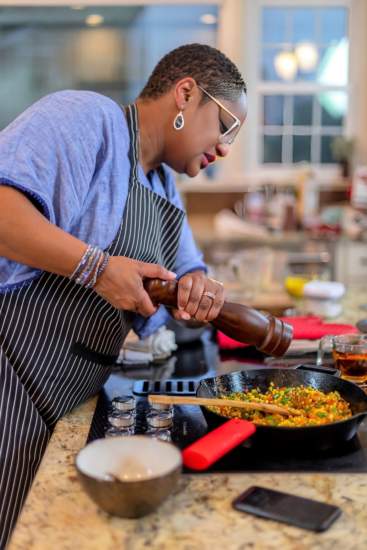 Chef Lorious seated at a bright table set for a meal