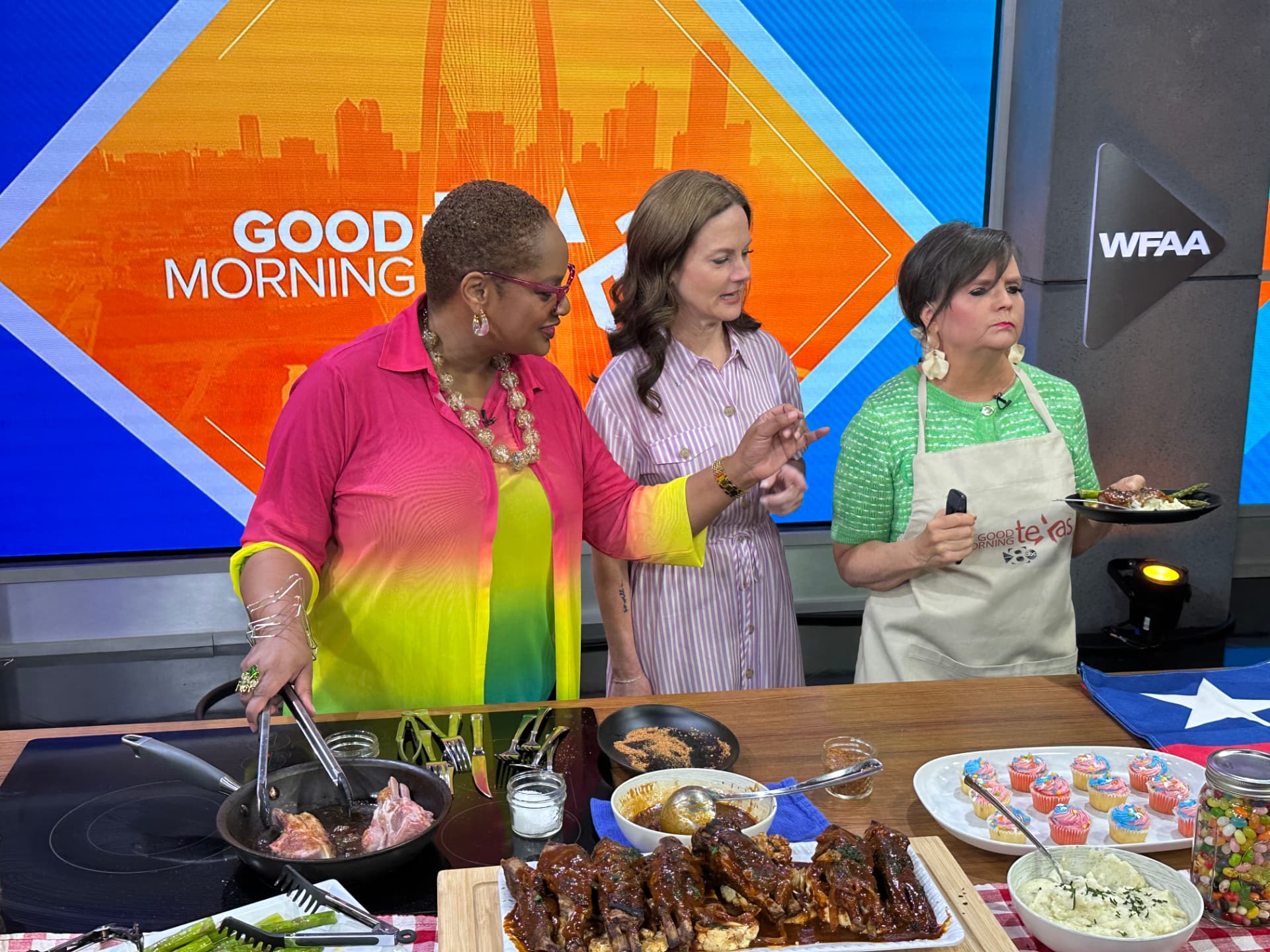 Chef Lorious cooking barbecue lamb chops with the hosts on the Good Morning Texas set