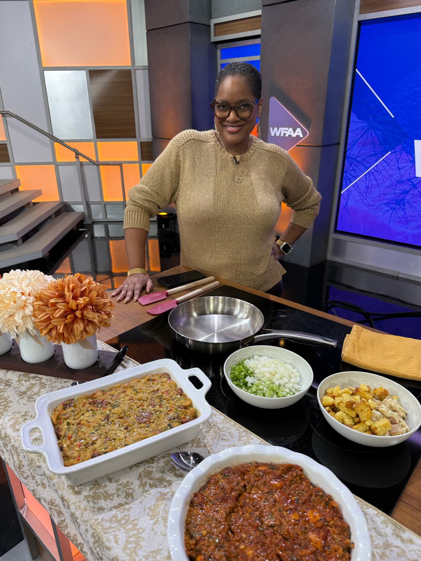 Chef Lorious beside two casseroles of cornbread dressing on the Good Morning Texas set
