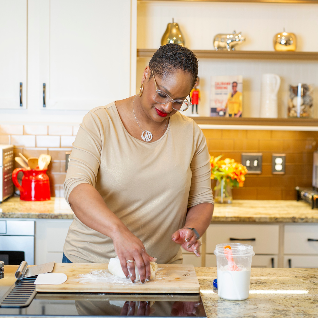 Chef Lorious kneading biscuit dough at her kitchen counter