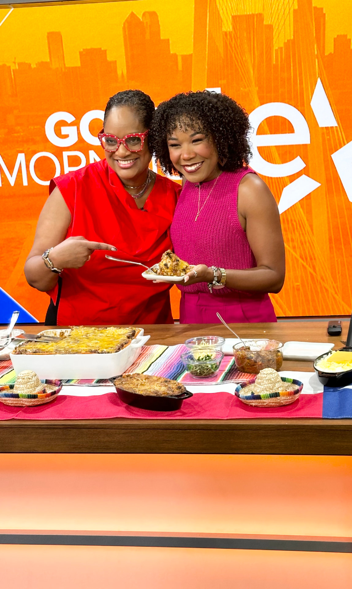 Chef Lorious with a host beside a baked Tex-Mex lasagna on the Good Morning Texas set