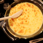 A pan of food with cheese and sauce.