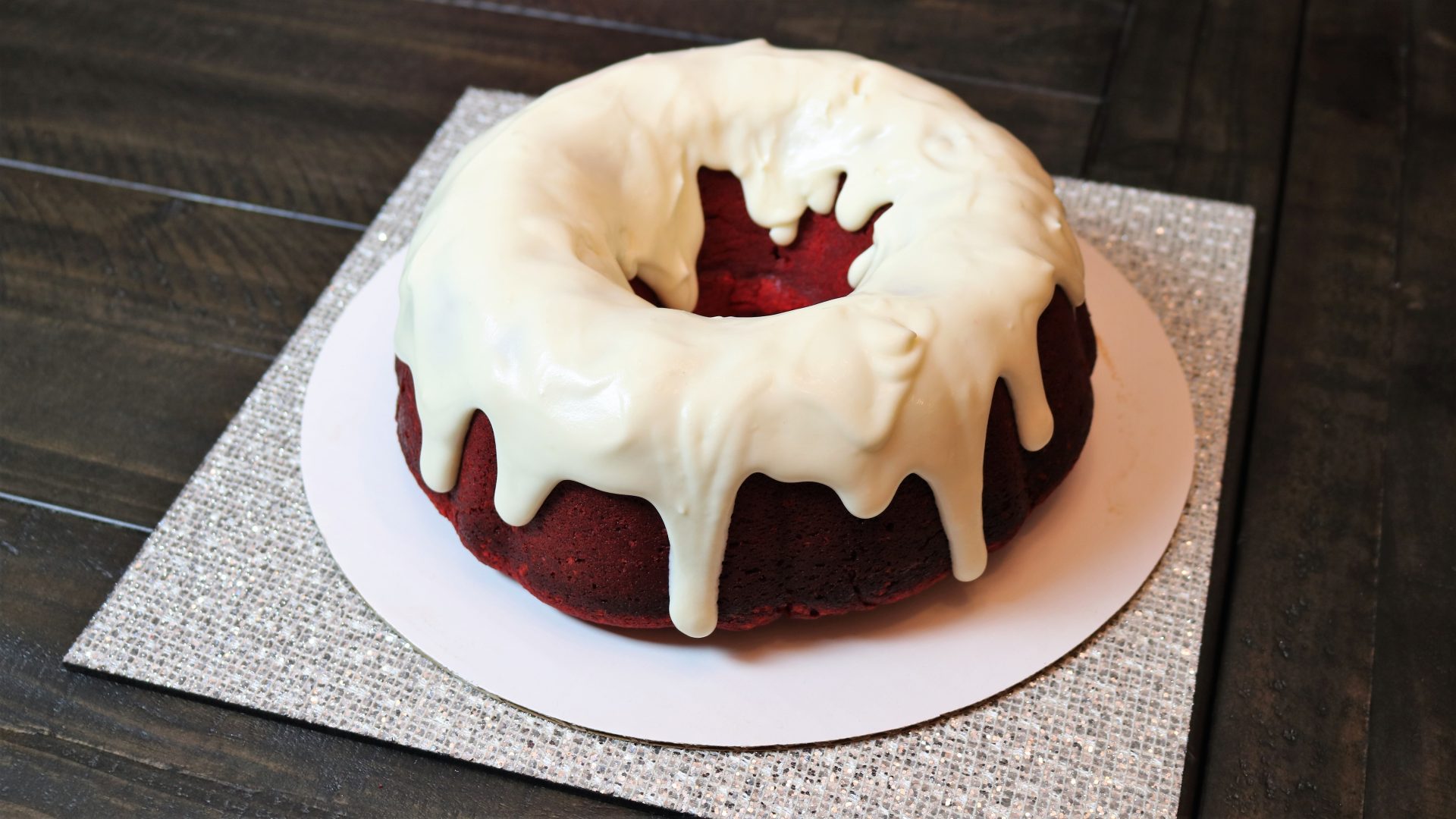 A red velvet cake with white frosting on top.