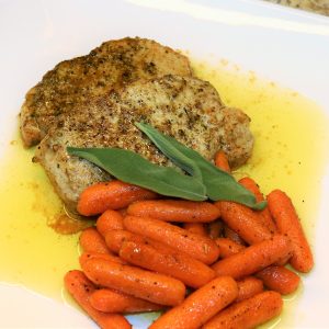 A plate of food with meat and carrots.