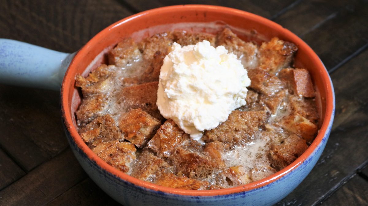 A bowl of food with ice cream on top.