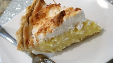 A piece of pie with coconut on top.