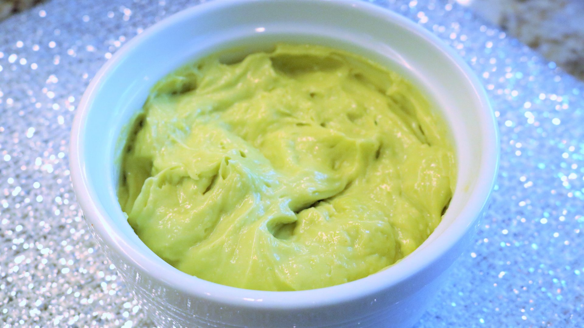 A bowl of guacamole is shown in this picture.