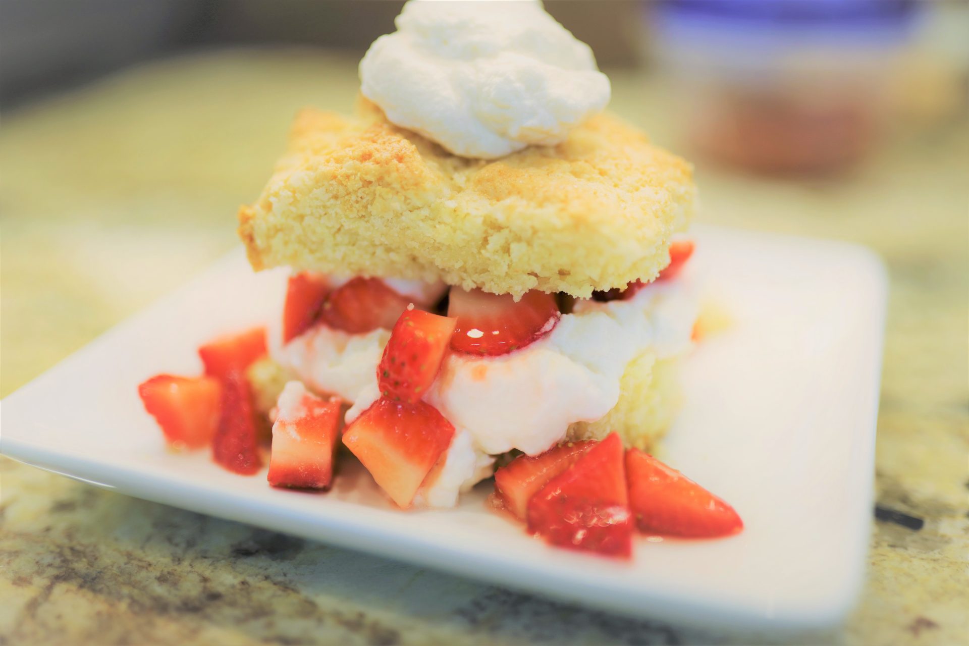 A white plate topped with cake and strawberries.