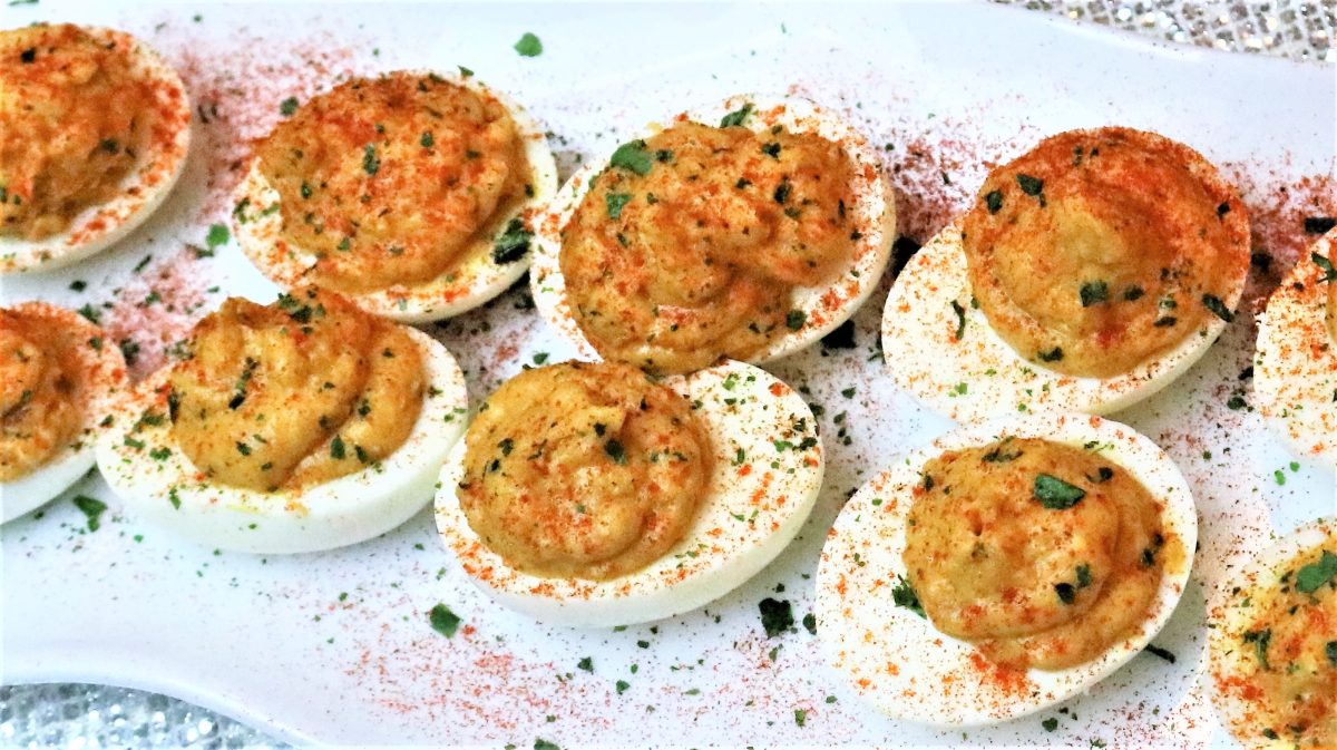 A plate of food with eggs and crab meat.