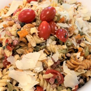 A close up of pasta with tomatoes and cheese