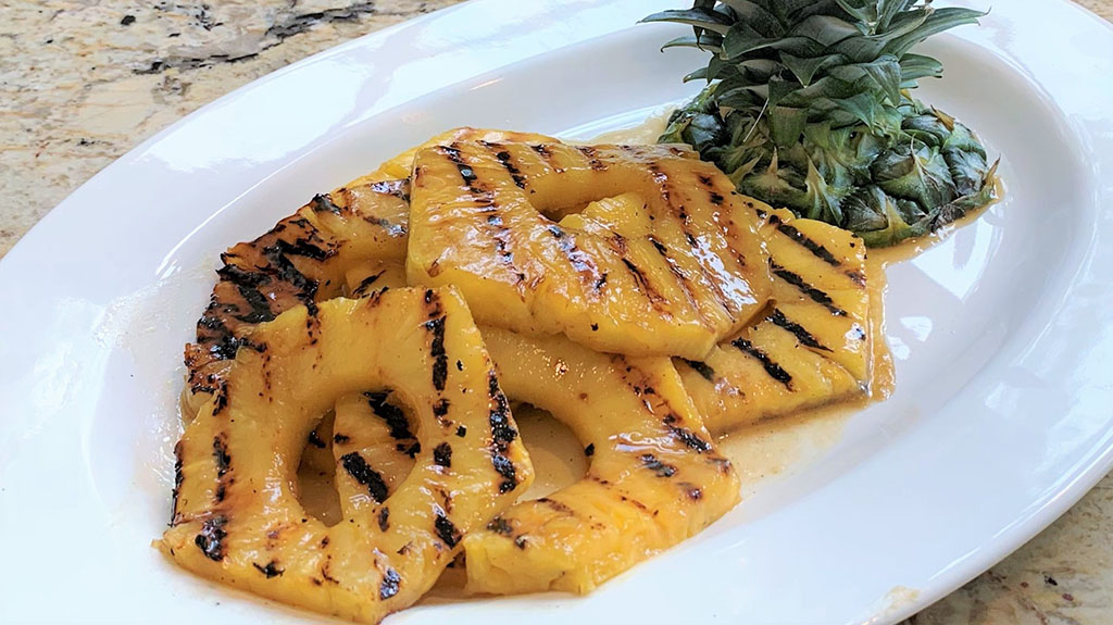A close up of grilled pineapple on a plate