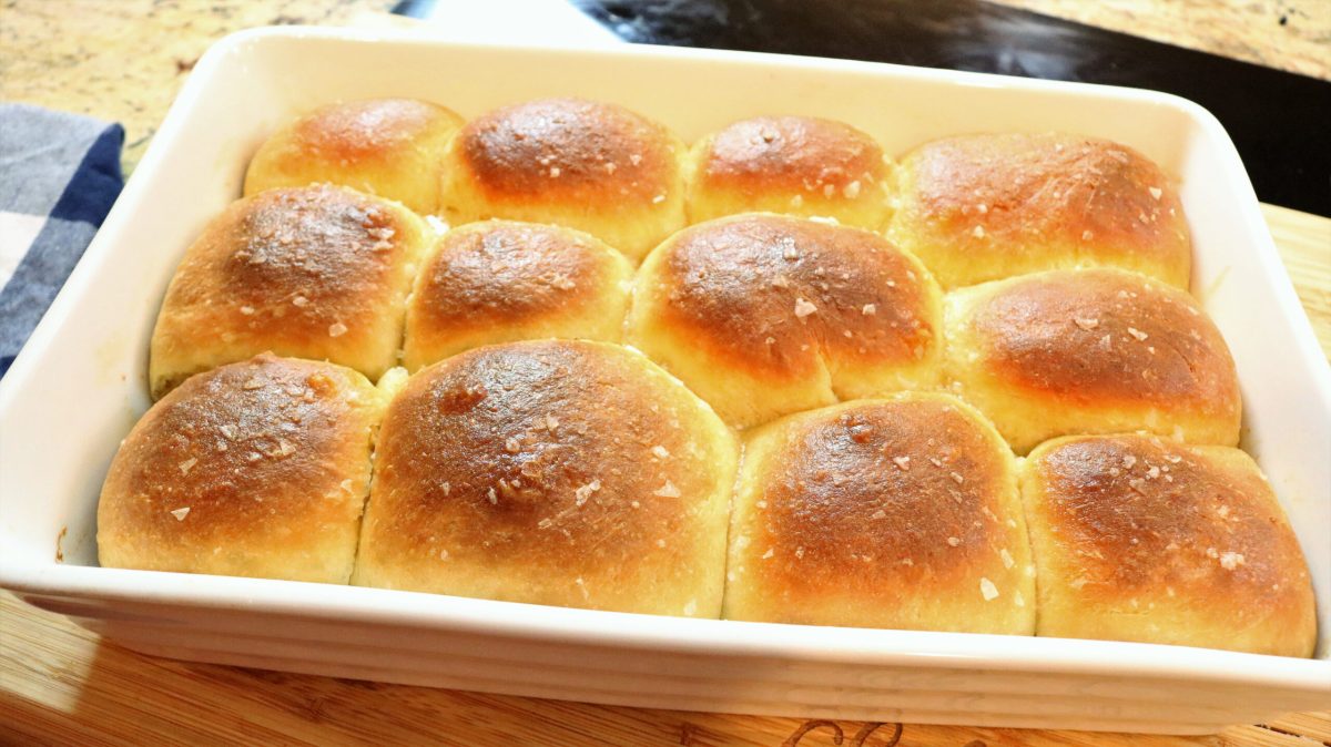 A pan of bread rolls with sea salt on top.