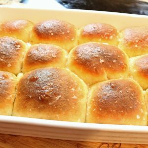 A pan of bread rolls with sea salt on top.