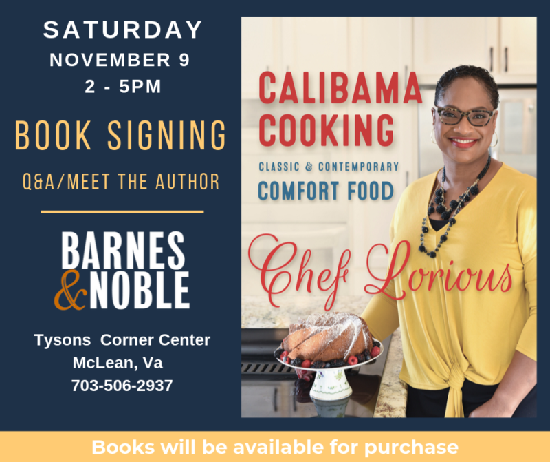 A woman standing next to a book signing.