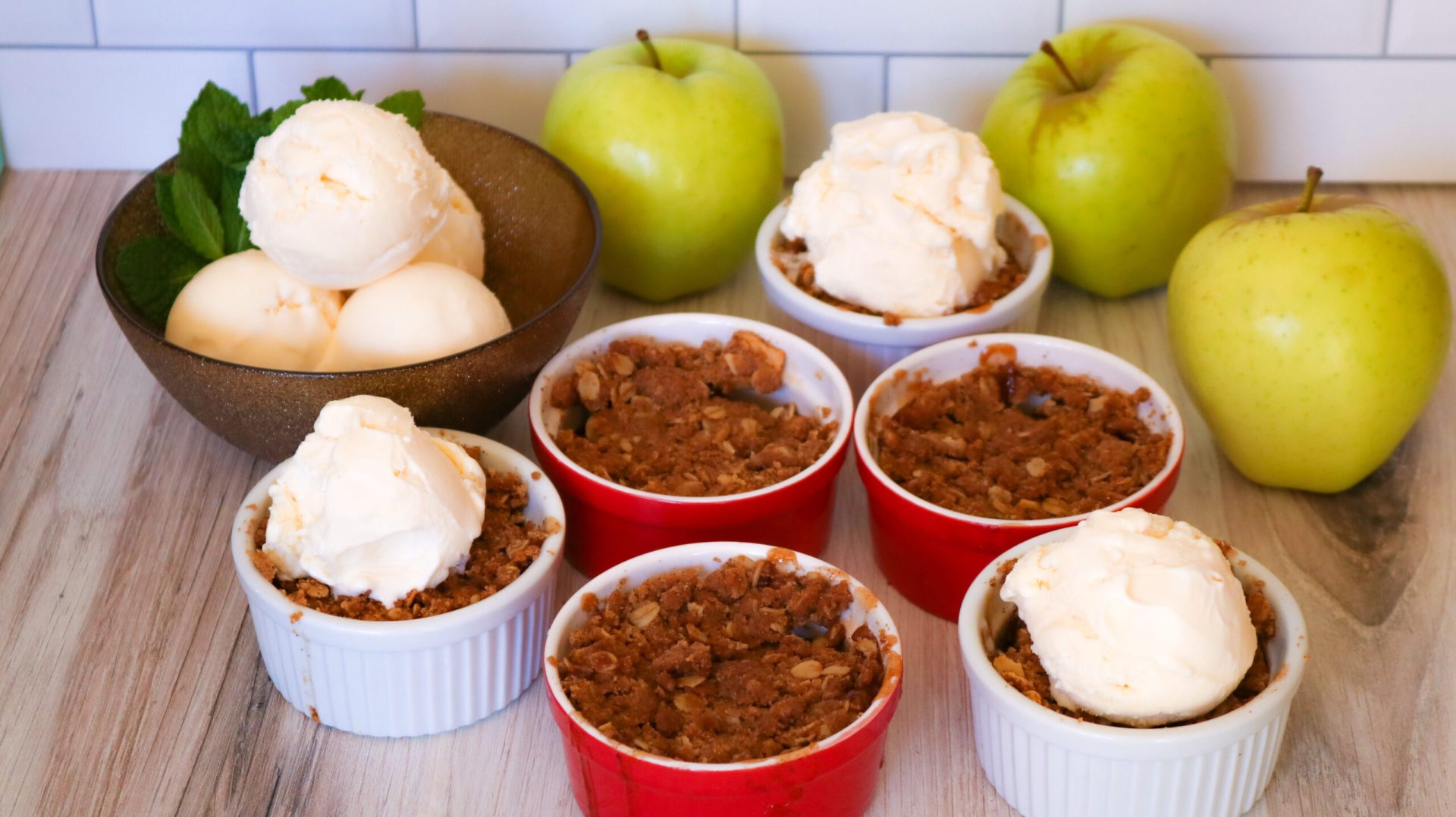 A table topped with bowls of apple cobbler.