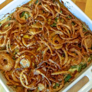 A casserole dish with some fried onions on top of it