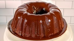 A chocolate bundt cake with melted chocolate on top.
