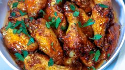 A close up of some chicken wings with parsley